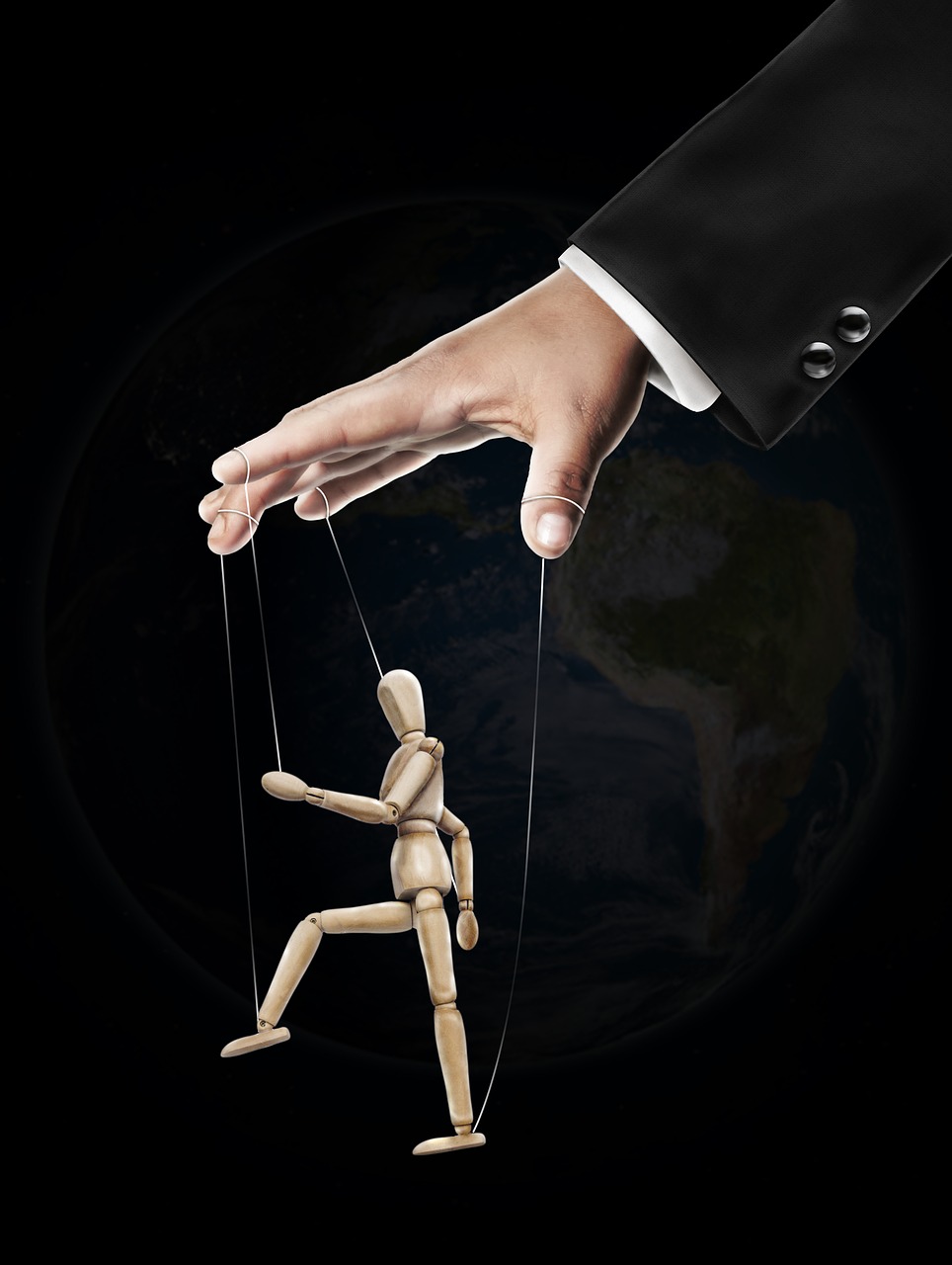 a puppet on strings in front of planet earth