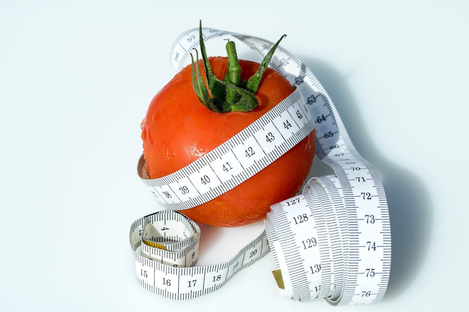 Tomato wrapped with a tape measure